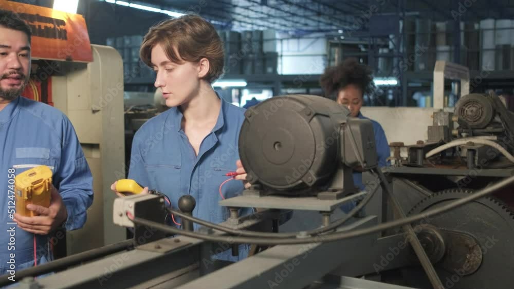 Multiracial professional industry engineer teams in safety uniforms work by inspecting machines' voltage current, checking, and maintaining at manufacture factory, electric system service occupations. Multiracial professional industry engineer teams in safety uniforms work by inspecting machines' voltage current, checking, and maintaining at manufacture factory, electric system service occupations.