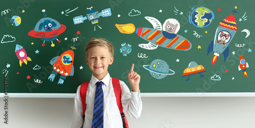 Little schoolboy near black...