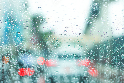 Blurred image of a car on the road on a rainy day.