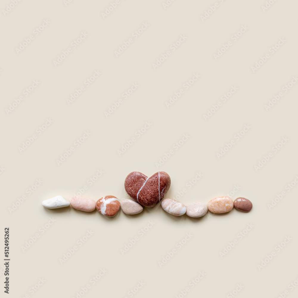 Aesthetic minimal flat lay sea pebble stones with heart, beige background. Composition from natural colored stone as wave. Balance, harmony, loving sea concept, top view card Aesthetic minimal flat lay sea pebble stones with heart, beige background. Composition from natural colored stone as wave. Balance, harmony, loving sea concept, top view card