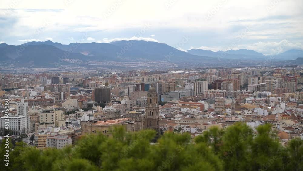 Malaga City behind green plants on clear day. Static shot Malaga City behind green plants on clear day. Static shot