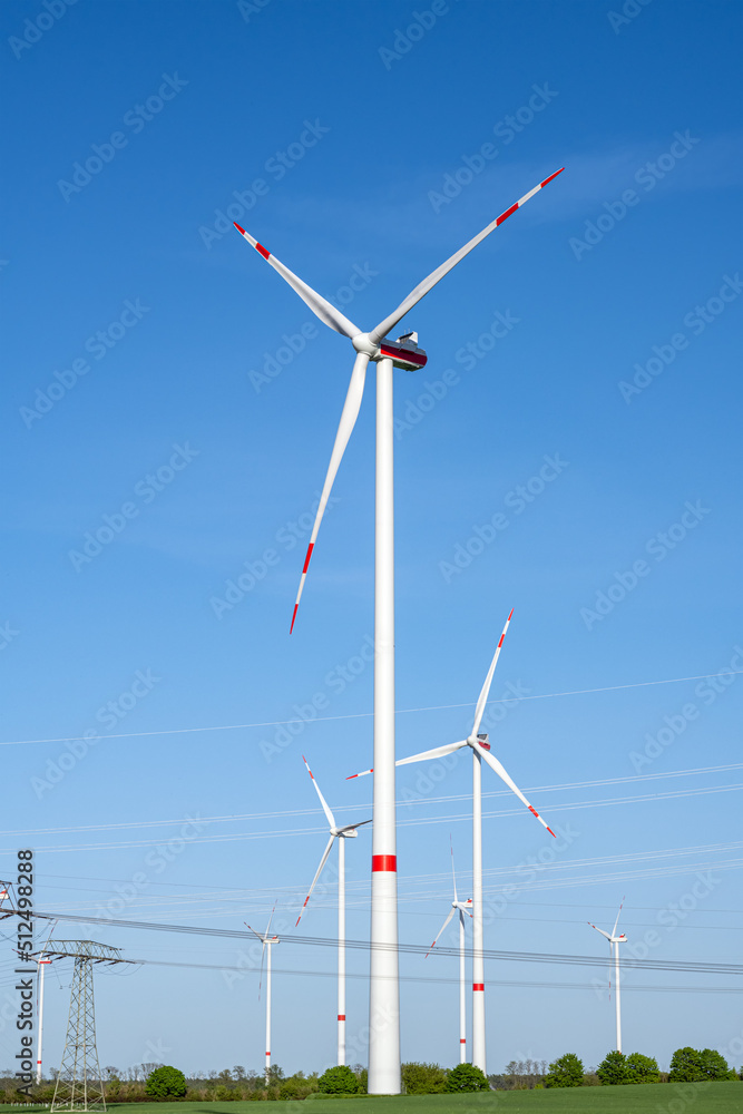 Wind turbines and power lines on a sunny day in Germany