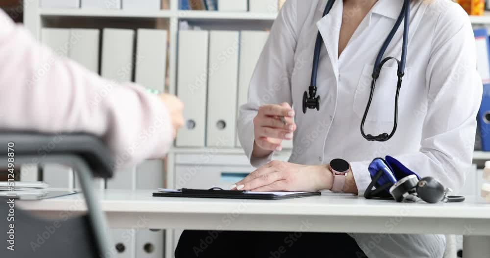 Doctor communicates with disabled patient in wheelchair in clinic Doctor communicates with disabled patient in wheelchair in clinic