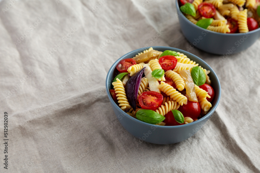 Homemade Fusilli Pasta Salad with Mozzarella and Vegetables, side view. Copy space.