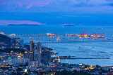 Khao Chalak Viewpoint of beautiful twilight light with buildings and cargo crane of the Sriracha Harbor in Sriracha city at Chonburi Province, Thailand 