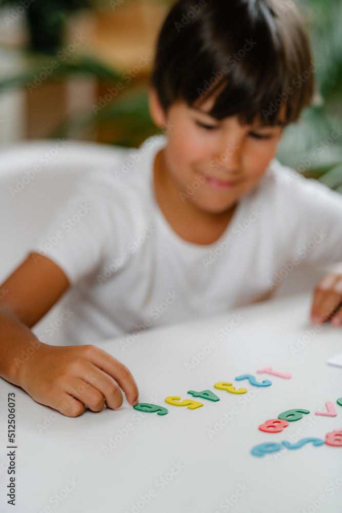 Preschooler boy starting math, exploring numbers Preschooler boy starting math, exploring numbers