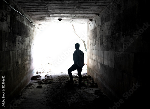 Close up photo of man hiding in the tunnel as a symbol of agoraphobia and timidity.