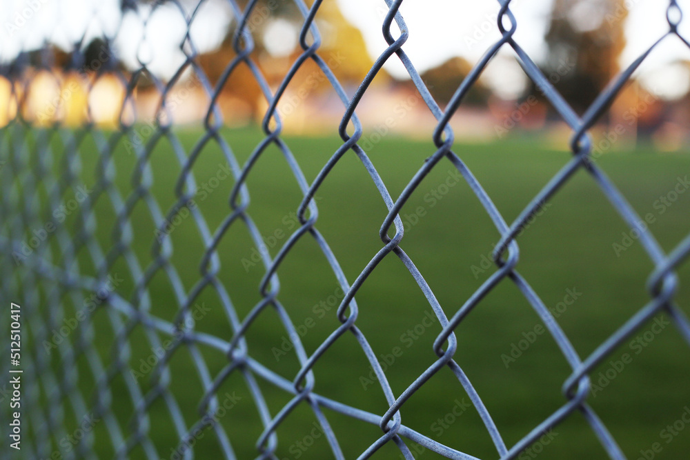Fototapeta premium Chain link fence, steel metal industrial pattern in court, selective focus