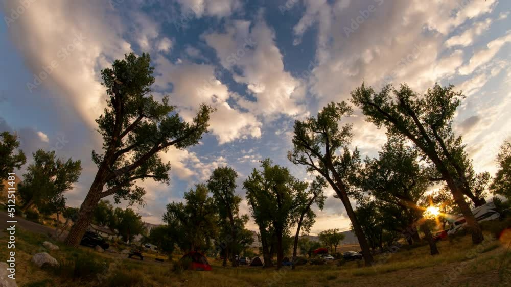 Super wide time lapse of campground at sunrise surrounded with trees reaching into the sky in Utah. Super wide time lapse of campground at sunrise surrounded with trees reaching into the sky in Utah.