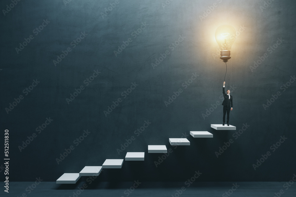 Innovation and idea concept with front view on businessman in suit on the top of white stairway turning on big light bulb on dark concrete background in empty hall Innovation and idea concept with front view on businessman in suit on the top of white stairway turning on big light bulb on dark concrete background in empty hall