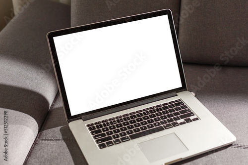 Blank screen laptop computer on sofa