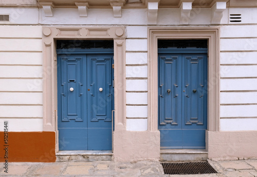 Traditional vintage painted wooden door in Malta. Popular travel destination. Entrance to house. Exterior of typical houses on the Mediterranean island of Malta - April, 2022.