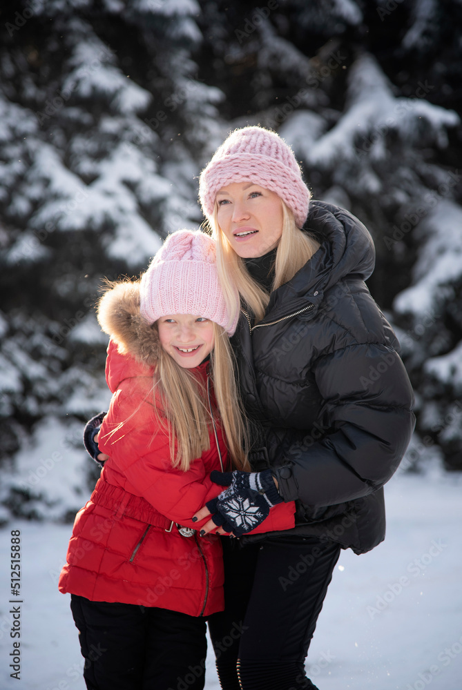 Fototapeta premium beautiful blonde mother with daughter having fun in winter park