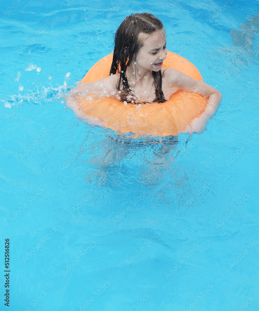 Child relaxing in swimming pool