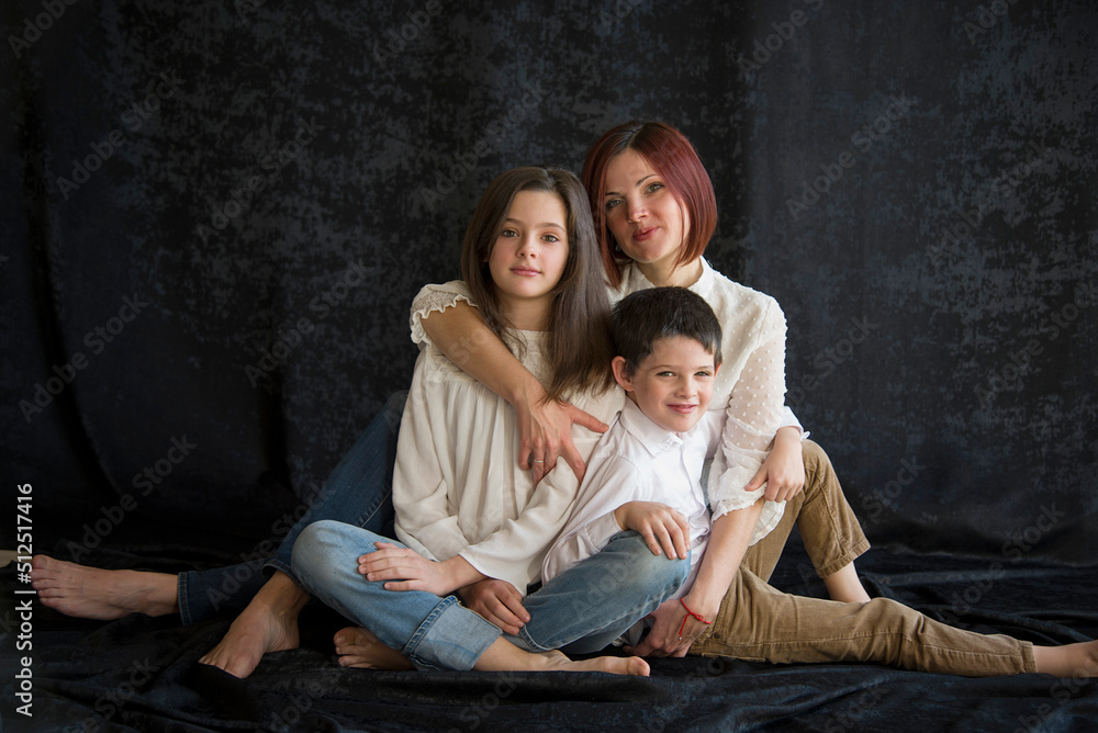 happy family with children in studio on black background