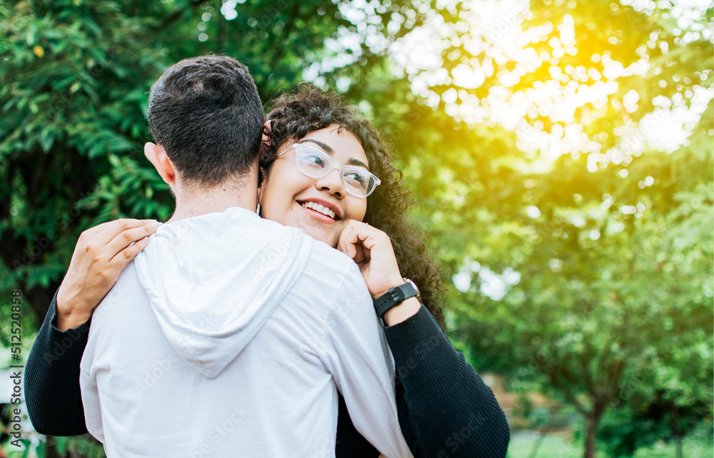 Teenage couple hugging outdoors, Close up of happy couple hugging in nature, Close up of smiling teenage couple hugging Teenage couple hugging outdoors, Close up of happy couple hugging in nature, Close up of smiling teenage couple hugging