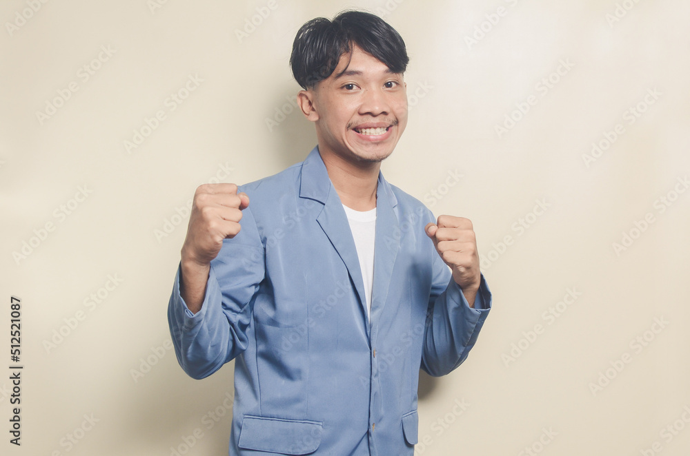 young asian man wearing college suit with expression showing enthusiasm on isolated background young asian man wearing college suit with expression showing enthusiasm on isolated background