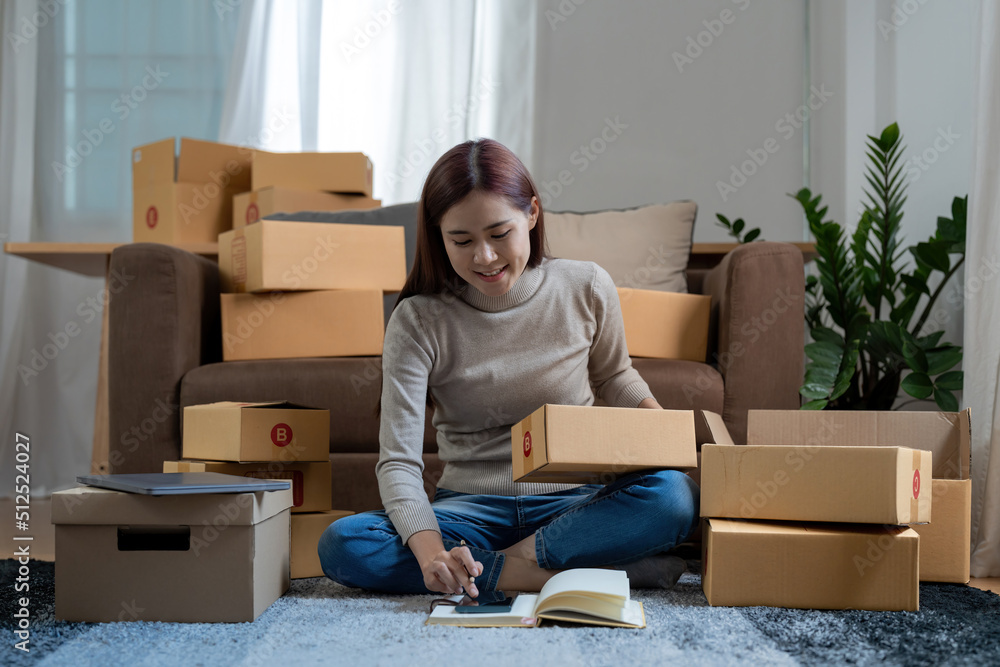 Close up businesswoman small stock business owner using phone and retail package parcel boxes checking commercial shipping delivery order on smartphone using mobile app technology. Close up businesswoman small stock business owner using phone and retail package parcel boxes checking commercial shipping delivery order on smartphone using mobile app technology.