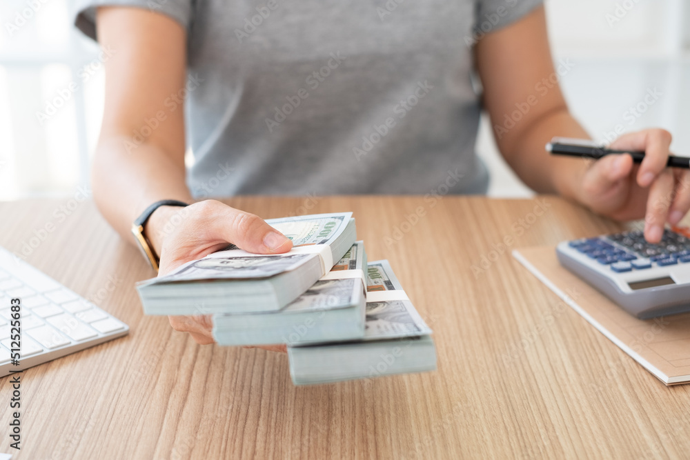 Fototapeta premium insurance claim revenue,finance, personal loan concept. women employer giving money banknote with employee.