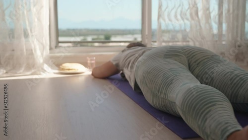 Overweight girl does fitness on a purple mat. Exercise 