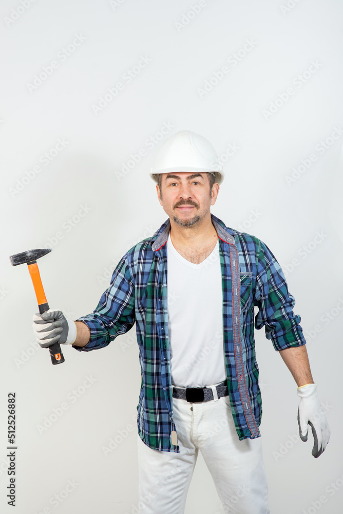 Male builder in a hard hat with a hammer on a white background Male builder in a hard hat with a hammer on a white background