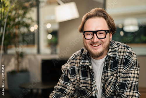 Young attractive male designer smiling at the camera. Video conference, call, profile picture, handsome businessman portrait, professional profession, person concept © Guys Who Shoot