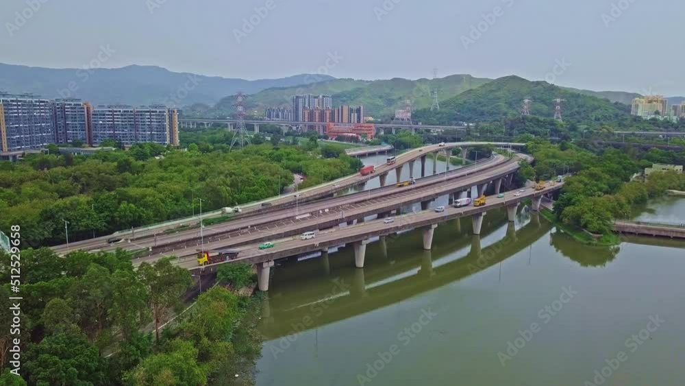 A dynamic aerial shot moving towards a highway above waters in Yuen Long in Hong Kong. Yuen Long Highway is an expressway connecting Au Tau in Yuen Long and Lam Tei in Tuen Mun of New Territories. A dynamic aerial shot moving towards a highway above waters in Yuen Long in Hong Kong. Yuen Long Highway is an expressway connecting Au Tau in Yuen Long and Lam Tei in Tuen Mun of New Territories.