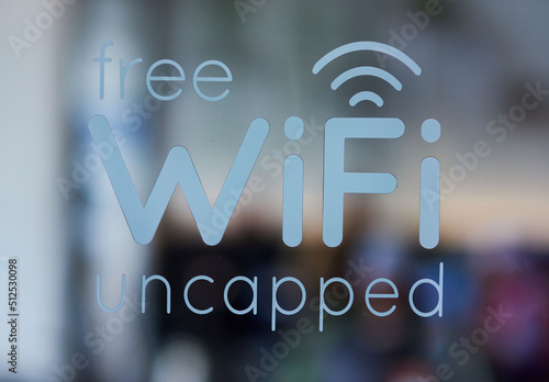 Free Wifi Uncapped decal on coffee shop window. photo