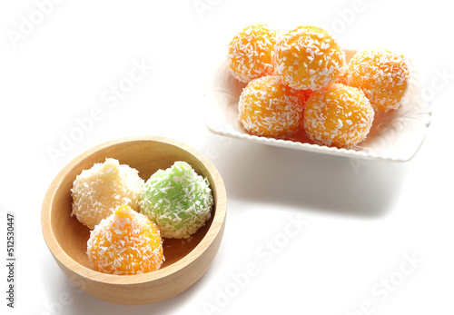 Close up of Indian sweet Motichoor Laddoo or Bundi Laddu. Coconut sweet Laddoo or Nariyal Ladduis on a white plate. 
Sweet Modak made using coconut on a wooden bowl. photo