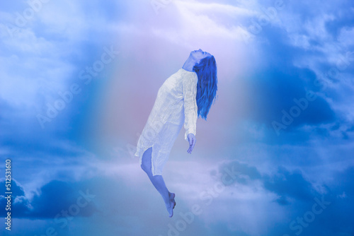 Ascension of the soul. The ghost of a woman ascends to heaven. Immortality, meditation, afterlife concept photo