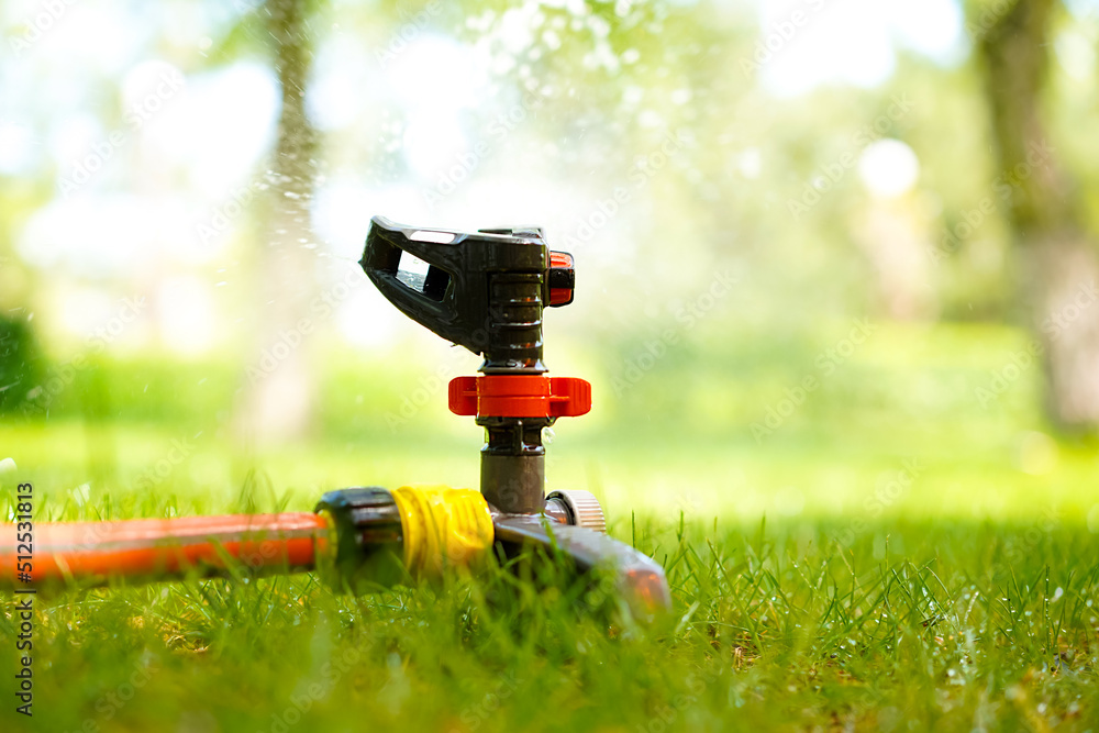 Automatic watering close-up. Irrigation of green lawn with water. Automatic watering close-up. Irrigation of green lawn with water.