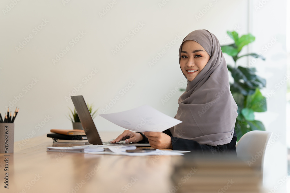Business Finance audit tax Concept. Portrait of Muslim Young business women analytics about marketing plan of this years. Business Finance audit tax Concept. Portrait of Muslim Young business women analytics about marketing plan of this years.