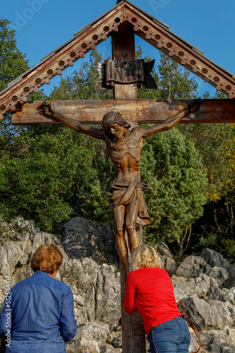 Fotobehang Pilgrims at the foot of the crucifix on top of the hill of apparitions, Podbrdo,