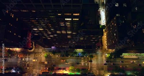 Transport moving by the light roads of metropolis. Gaze at the busy traffic from bird's eye perspective.