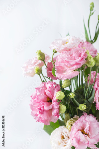 Pink lisianthus flowers in white vase © nolonely