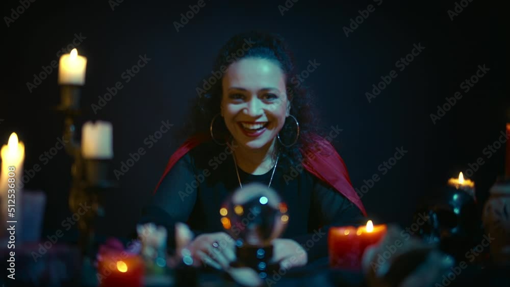 Woman psychic laughing with evil laugh, predicting bad future, provoking fate Woman psychic laughing with evil laugh, predicting bad future, provoking fate