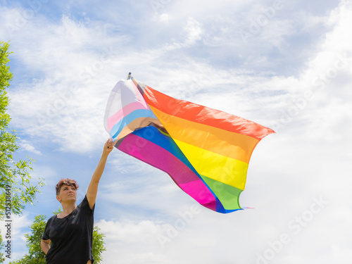 Pride day 2022. Young lesbian girl waving the lgbt flag on the pride day. Celebrating the lgbtq  lesbian  gay  bisexual  transgender and queer rights.