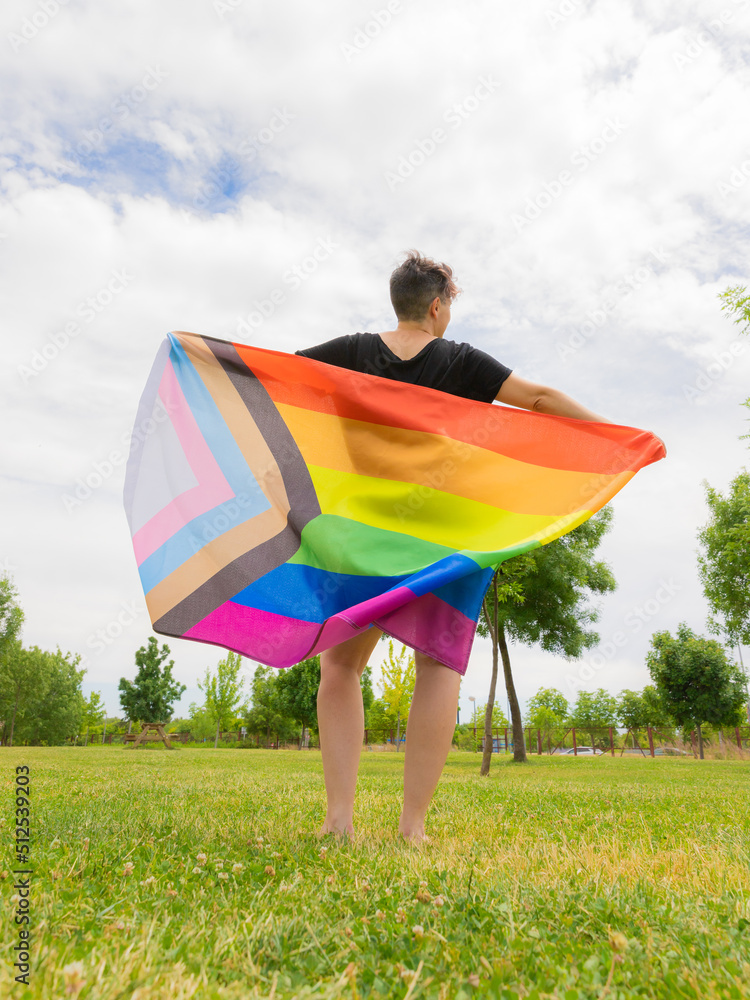 Pride day 2022. Young lesbian girl waving the lgbt flag on the pride day. Celebrating the lgbtq, lesbian, gay, bisexual, transgender and queer rights.