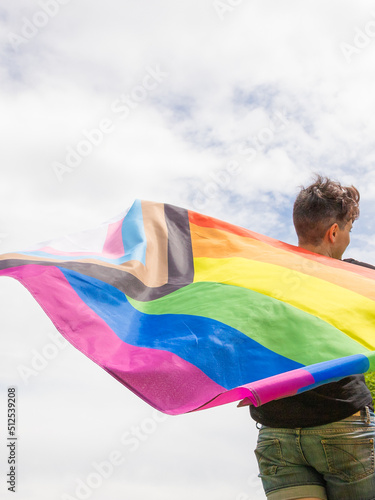 Pride day 2022. Young lesbian girl waving the lgbt flag on the pride day. Celebrating the lgbtq, lesbian, gay, bisexual, transgender and queer rights.