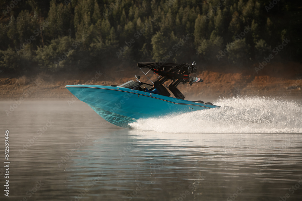 Fototapeta premium wonderful view of modern bright blue motorboat quickly floating on the water