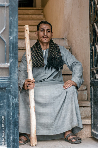 An Arab man from the village sits at the entrance of his house. photo