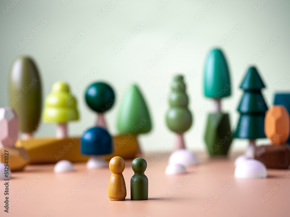 Figures of men on the background of wooden figurines of trees . The concept of nature, ecology, respect for nature.