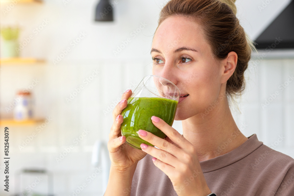 Healthy lifestyle, diet, weight loss concept. Portrait of woman drinking green smoothie close-up. Healthy food, breakfast. Vegetarian, vegan food - obrazy, fototapety, plakaty 