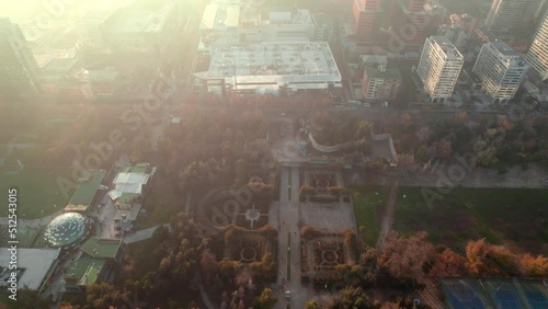 Aerial dolly in view of the gardens in autumn at Parque Araucano with the sun rays on the side, Las Condes, Santiago, Chile. photo