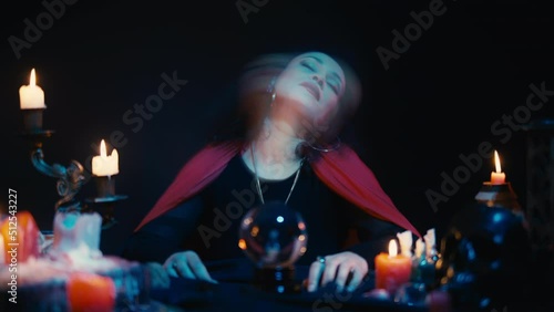 Black witch falling into a trance state, communicating with ghosts, possession photo