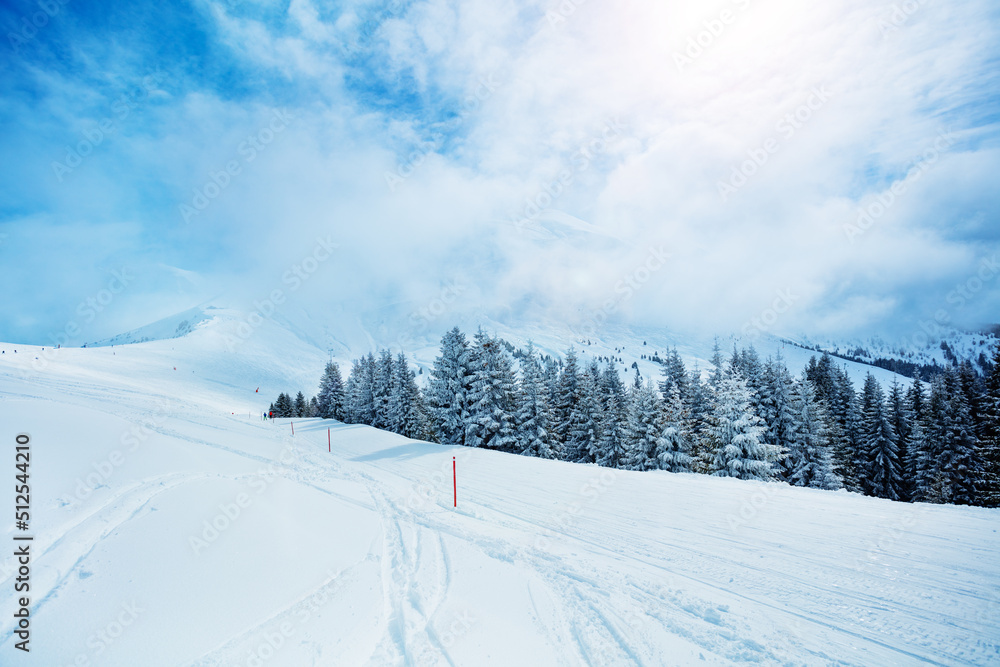 Ski track in the mountain range and valley covered with snow Ski track in the mountain range and valley covered with snow