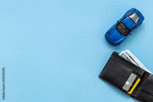 Toy car with wallet and money. Purchase a car concept