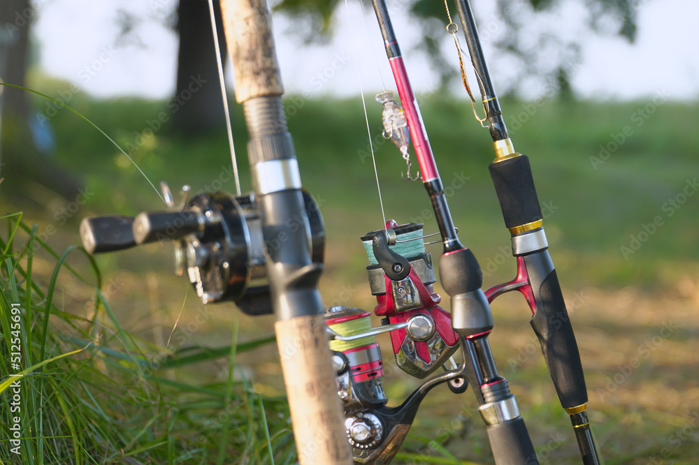 Spinning rods with reels and lures ready for fishing Spinning rods with reels and lures ready for fishing