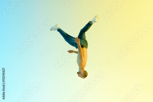 Acrobat doing back flip in studio