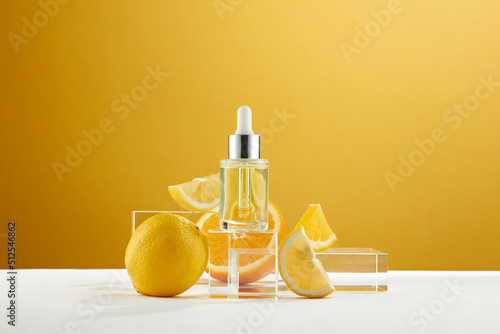 A front view of lemon decorated with cosmetic jar and transparent podium in orange background 